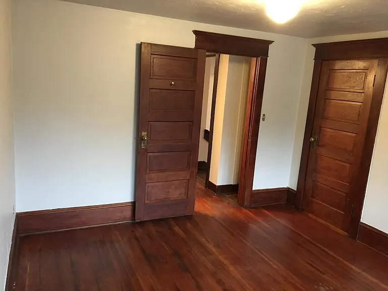 Bedroom showing wood flooring and doors