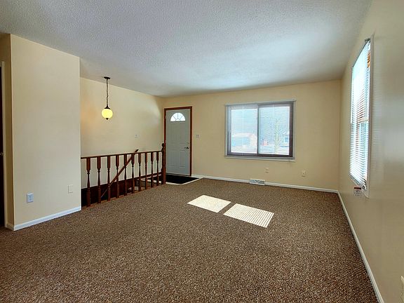 Living Room w/ Staircase to Basement