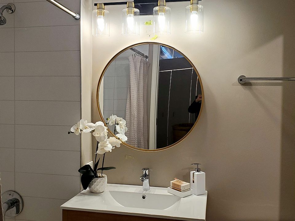 Bathroom with new tiles, vanity and lighting, faucets