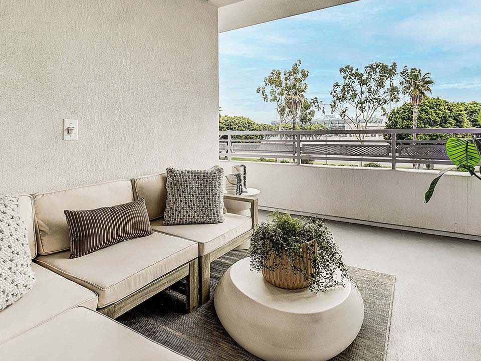 Griffis Platinum Triangle apartment balcony with lounge chairs.