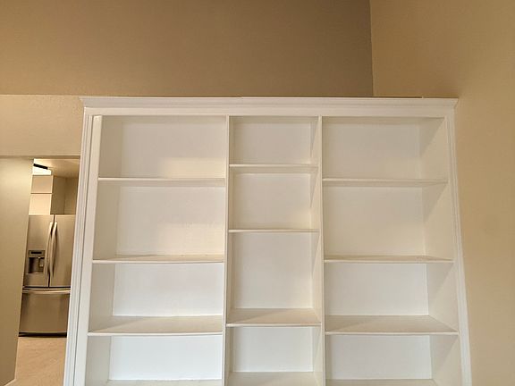 Bookshelf and loft storage space in living room.