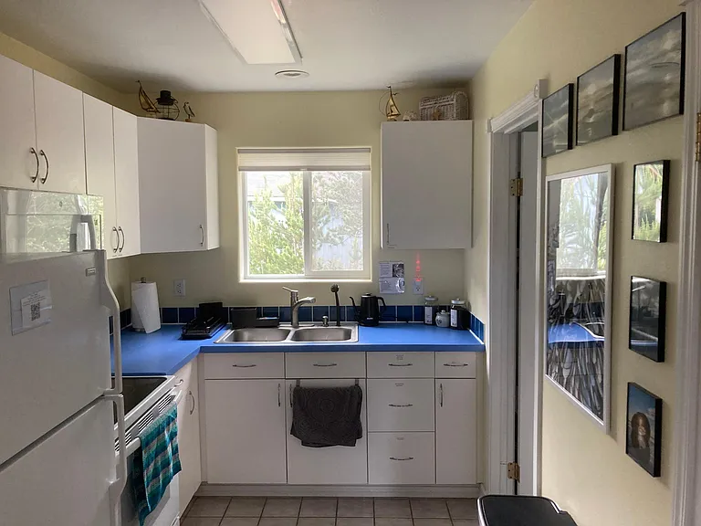 Full kitchen with toaster oven, microwave, range, coffee maker and fridge