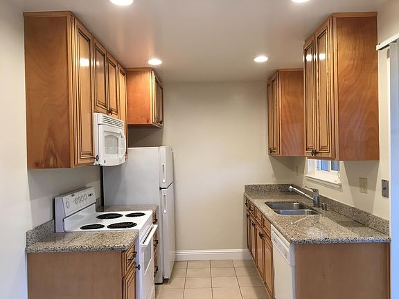 Dishwasher, disposal, built in microwave oven, electric range, refrigerator, granite countertops.