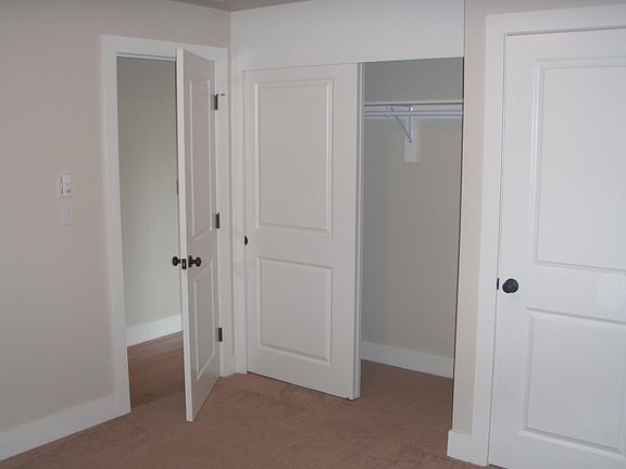 Bedroom with large closet and washer/dryer.
