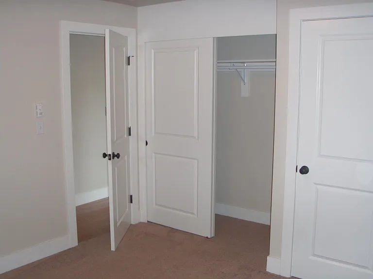 Bedroom with large closet and washer/dryer.