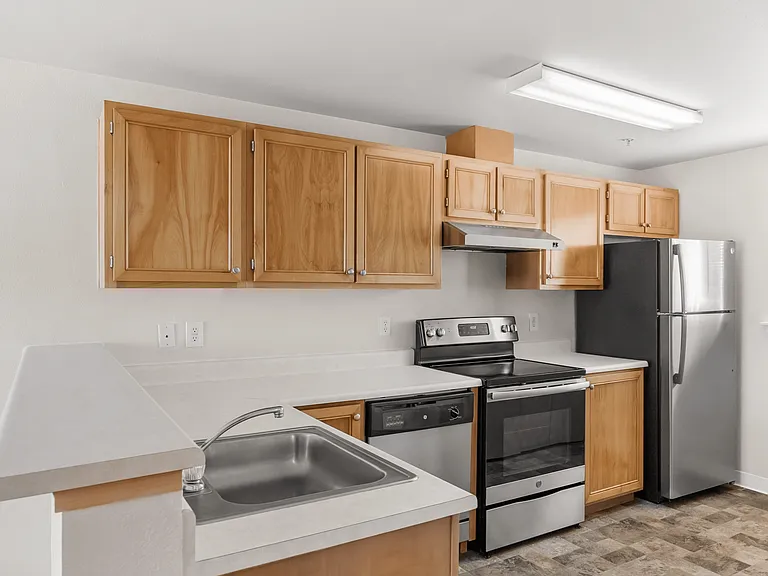 Bright kitchen featuring stainless steel appliances and ample cabinet storage. Bright kitchen featuring stainless steel appliances and ample cabinet storage.