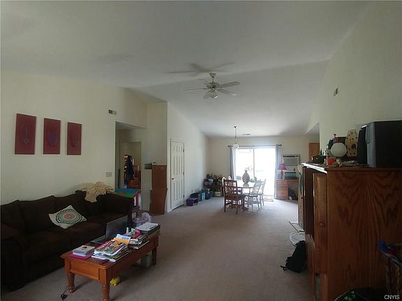 Living room, accented by a cathedral ceiling, is open to dining area allowing for plenty of natural light.