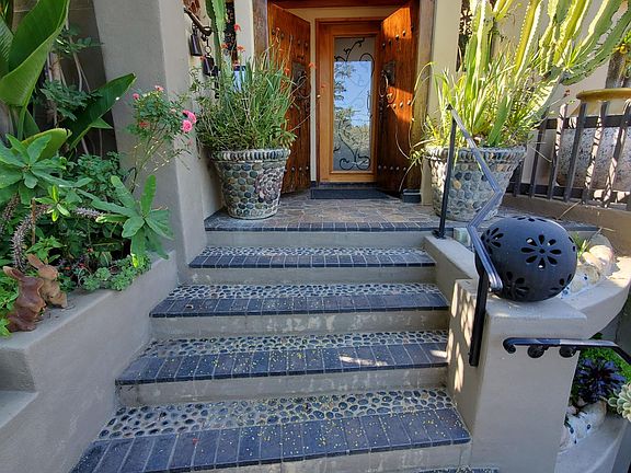 Steps to front door with open gate.