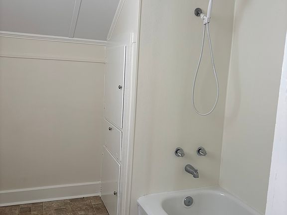 Full bathroom with tub & storage closet
