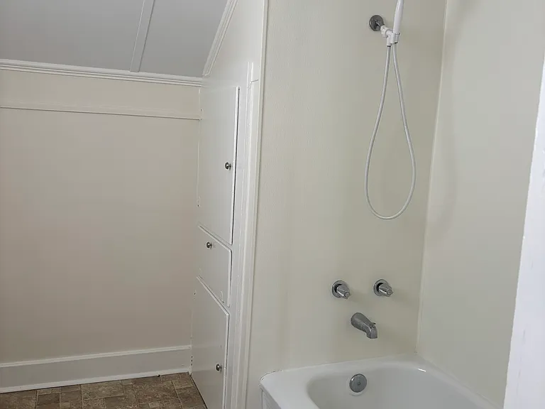 Full bathroom with tub & storage closet