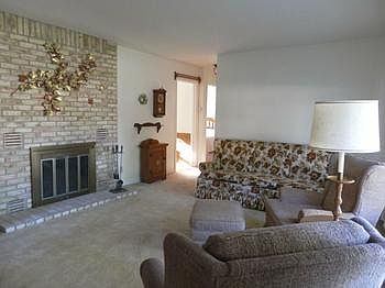 Living room offers brick woodburning fireplace