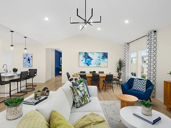Great room with vaulted ceiling and chandelier