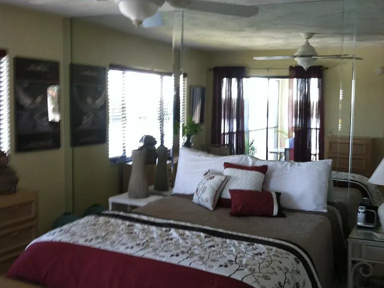 Large master bedroom with en suite bathroom, patio sliders lead out to back porch