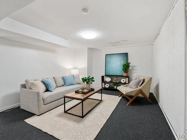 Finished lower level ~ laundry area and walk-out to back parking pad.