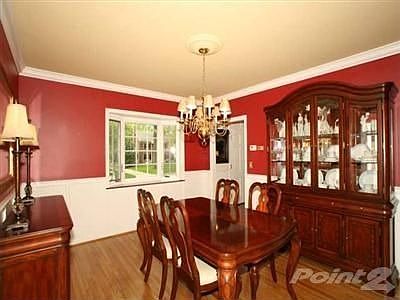 Exquisite detailing add charm to the formal dining room. Hardwood flooring, wide moldings around cei