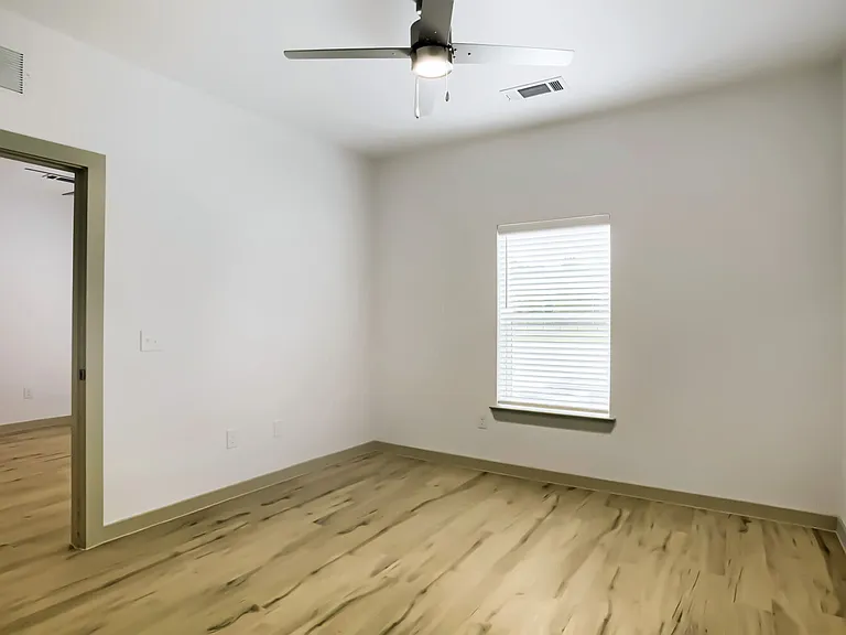bedroom with window and ceiling fan