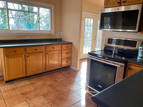 Kitchen is south facing with morning sunlight. High end appliances. French doors from dining room open to large deck