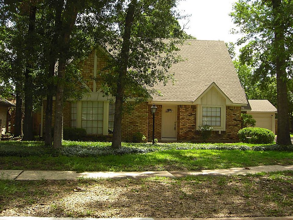 Front of home with mature trees for summer shade