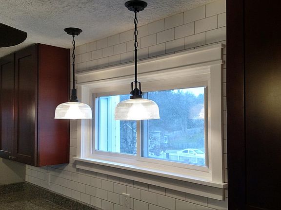 The kitchen window and lots of pendant lighting to brighten up the workspace.