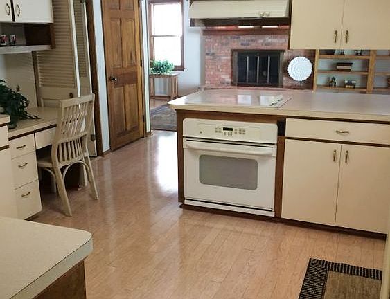 View of kitchen area - pre-finished maple floors, new laminate counters in 2006 along with stove top and oven.