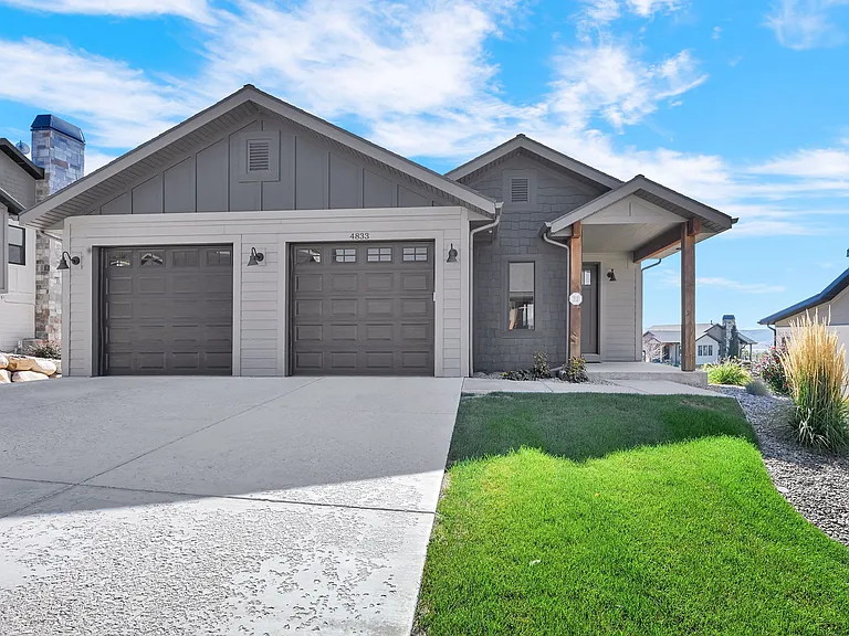 Front of home with two car garage and driveway
