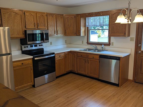 Kitchen with new refrigerator and 2 yr. old stove/over and dishwasher.