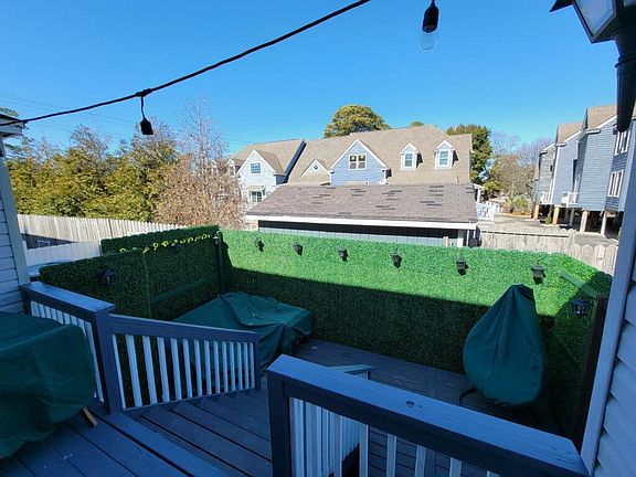 Outside deck area with patio furniture and covers included.