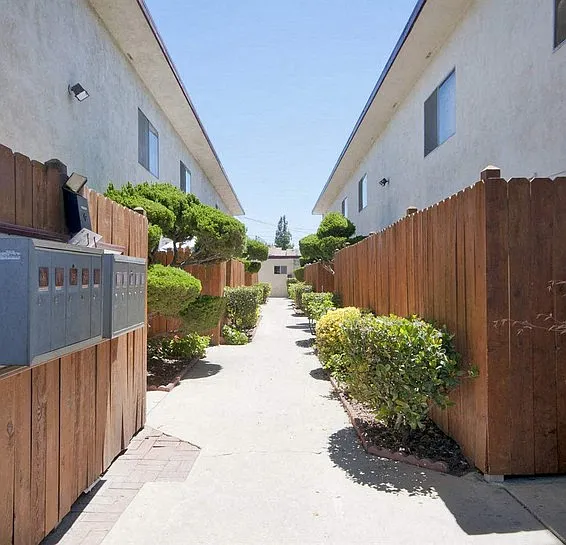Walkway, wood fence of the patios, mail boxes on the left