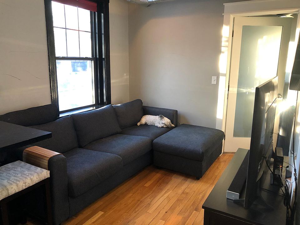 Living room with couch, ottoman, table & chair set, TV and TV stand