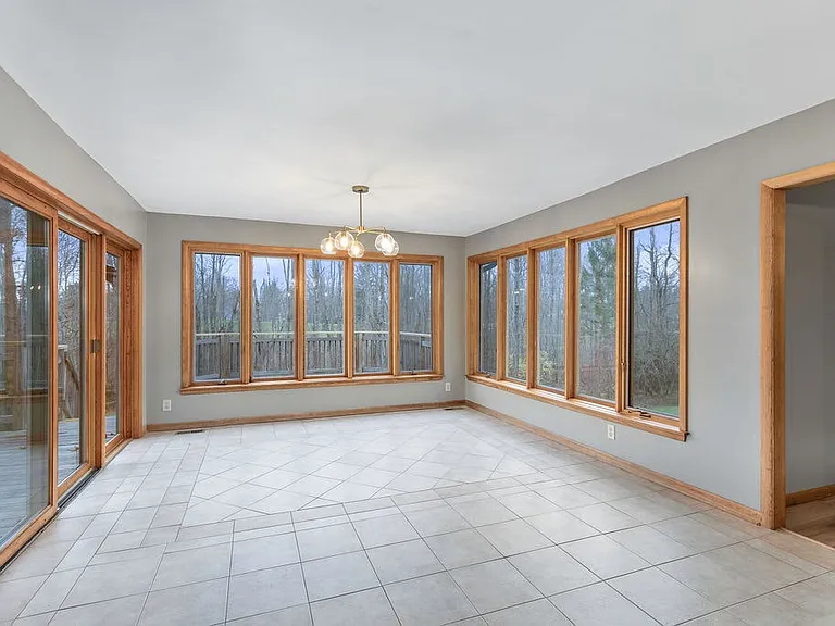 Full window breakfast room opens to a large deck