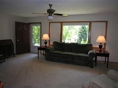 Spacious living room with tile entry, sunny view