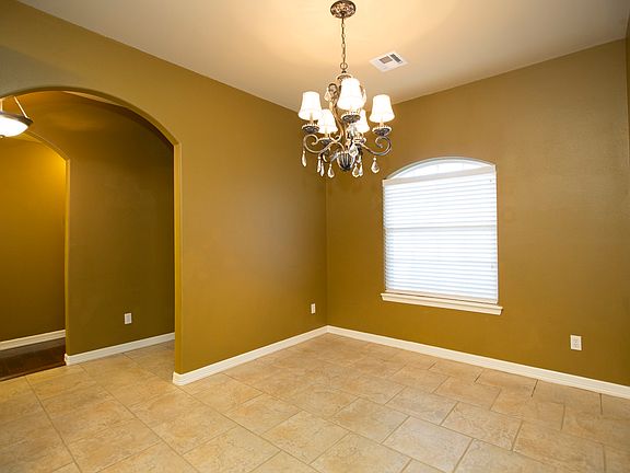 Elegant light fixture in dining rm