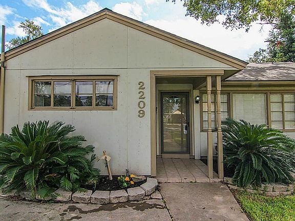 A closer view of the entry with updated landscaping and a covered entry for your guests.