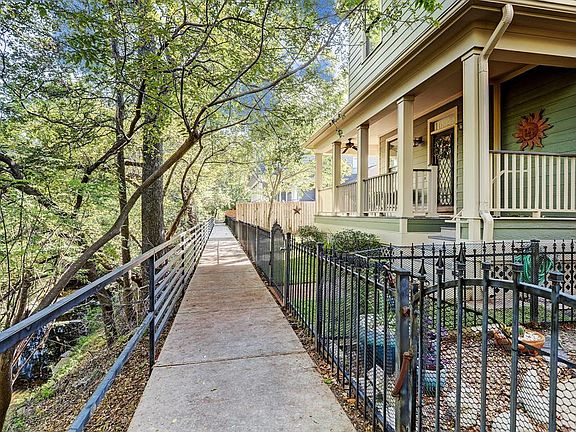 Your home overlooks the ravine and you can hear the peaceful water trickle from your front porch.