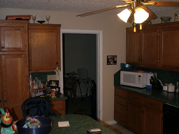 View of kitchen from stove.  That table seats five.