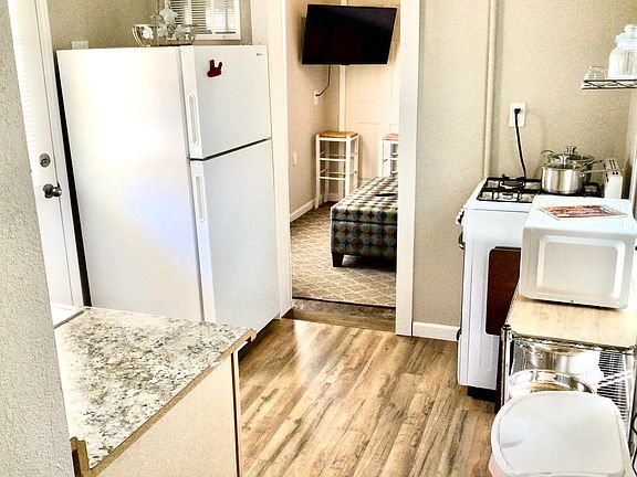 Full kitchen w/ full sized refrigerator, medium sized gas oven/stove, microwave, all plates/glasses, pots/pans & utensils needed