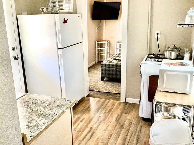Full kitchen w/ full sized refrigerator, medium sized gas oven/stove, microwave, all plates/glasses, pots/pans & utensils needed