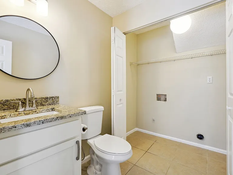 Mainfloor half bath with washer/dryer closet.