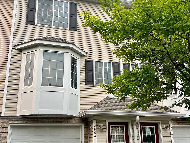 Exterior of 3 story townhome, entry at ground level, living room, kitchen and 1/2 bath on second level, 2 bedrooms, full bath and laundry on 3rd level
