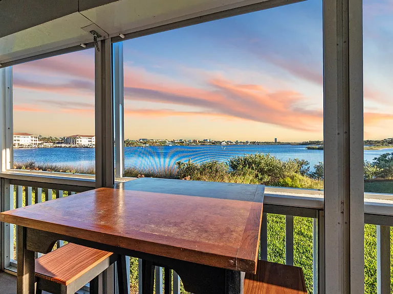 Dine al fresco at the high-top table on the beautiful screened-in porch or relax with a good book while enjoying the gorgeous sunset views.