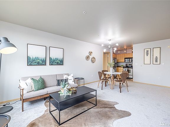 Open concept living with kitchen opening up to dining area and living room.