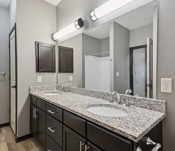 Start and end your day with ease at this double-sink vanity, featuring granite countertops, ample storage, and an oversized mirror for a polished routine.
