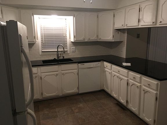 Kitchen with granite countertops. Gas stove, over stove microwave, dishwasher and 5 year old fridge stay.