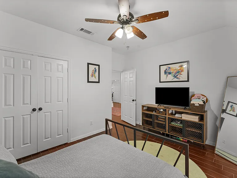 Relaxing queen room with a soft, comfy feel and a TV.