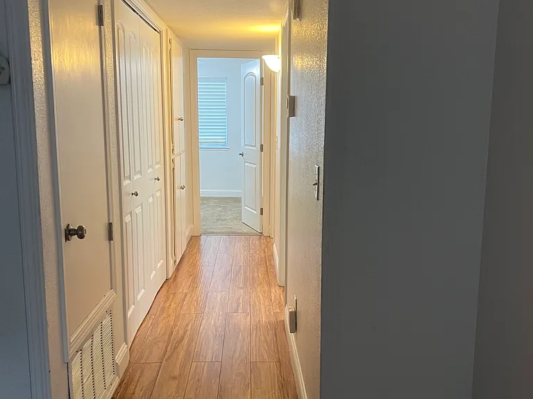 Hallway to bedrooms, laundry closet, linen closet and second bathroom.