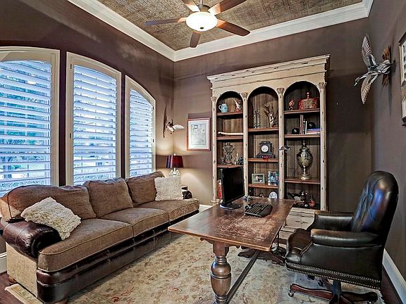 Office with the gorgeous wood flooring, plantation shutters and custom steel ceiling stamping.
