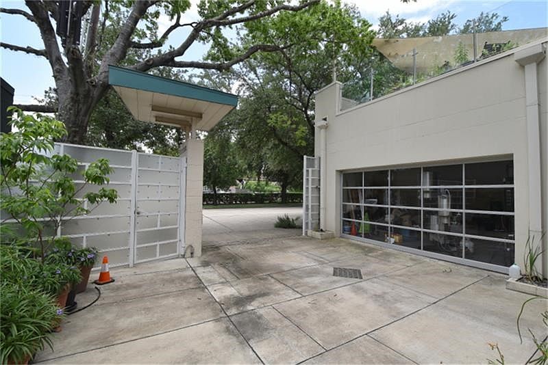 A remote limited access gate opens to motorcade front yard area that curves to the 2plus car garage that is accented with glass garage doors. This is not the only outdoor space for this home. In fact every room has access to generous outdoor spaces!