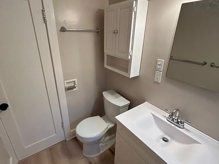 Storage in vanity and cabinet over toilet.