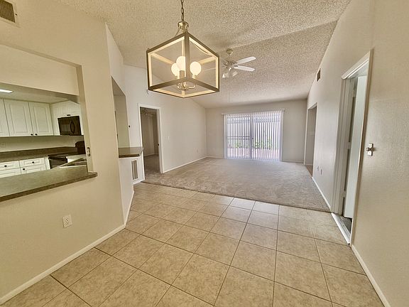 Lounge view from dining area with 2 way sliding doors to enclosed patio.