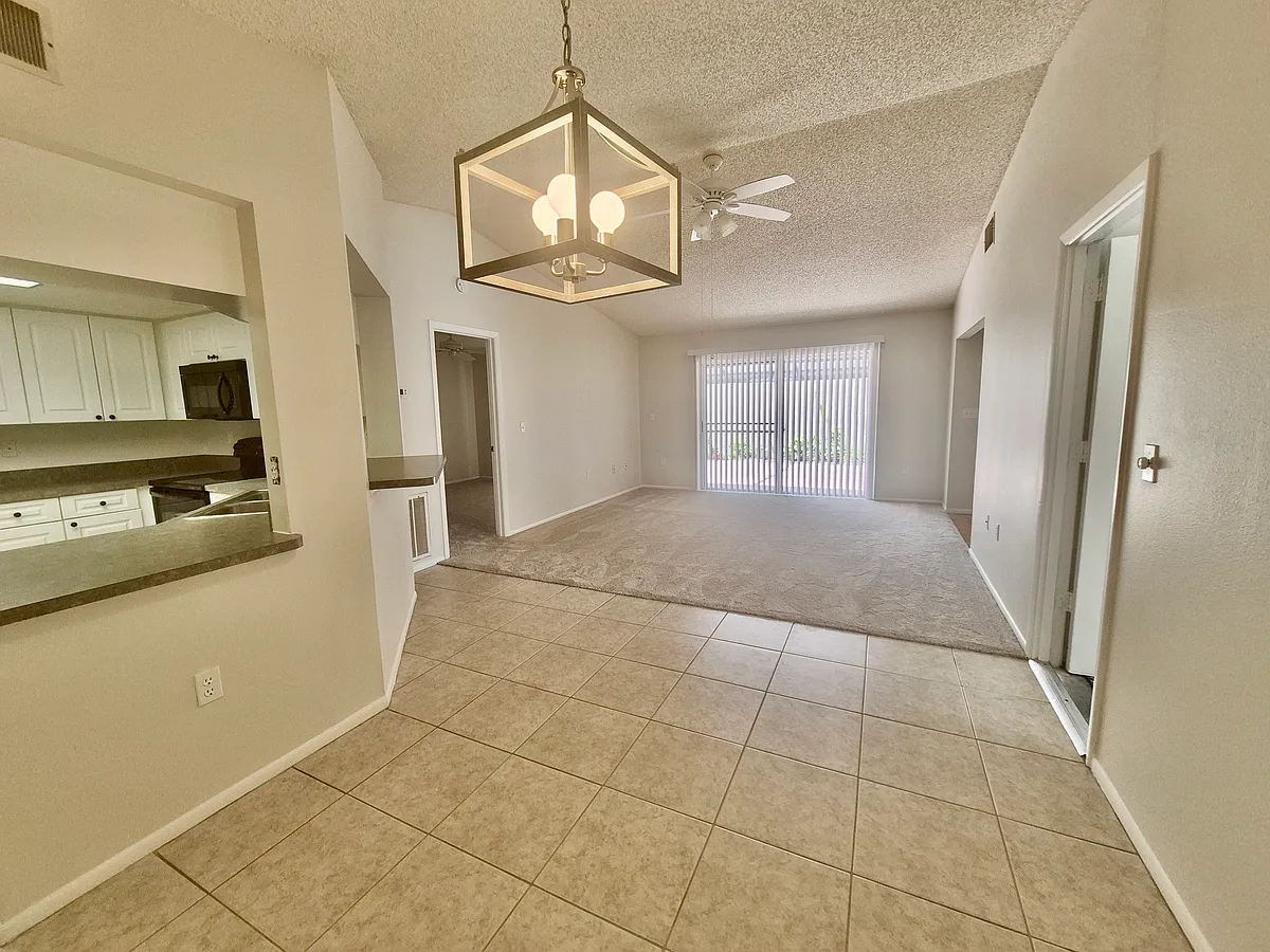 Lounge view from dining area with 2 way sliding doors to enclosed patio. - 4090 Center Pointe Pl